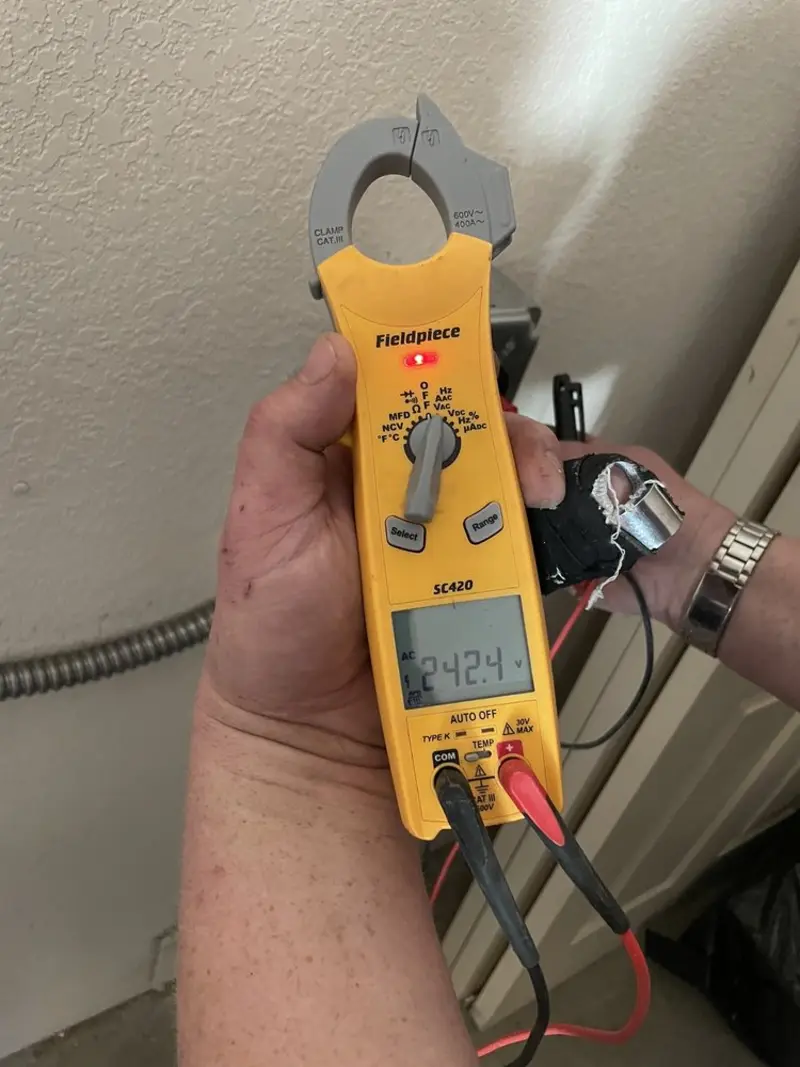 Voltage testing with clamp meter during Outlet Installation in Euclid